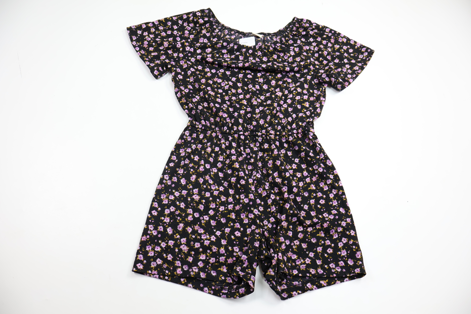 Blommig jumpsuit från Lindex - Storlek 128 - Svart